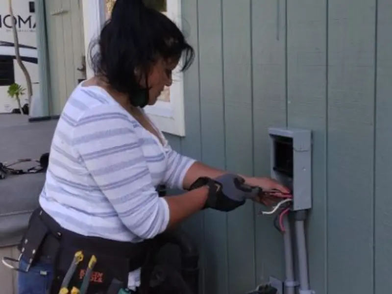 Licensed electrician wiring an exterior subpanel in Albany
